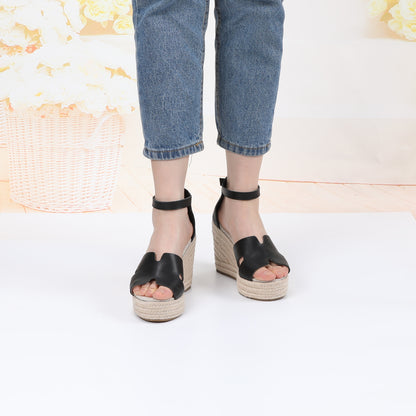 TONIVIS black leather platform wedge sandals on model front