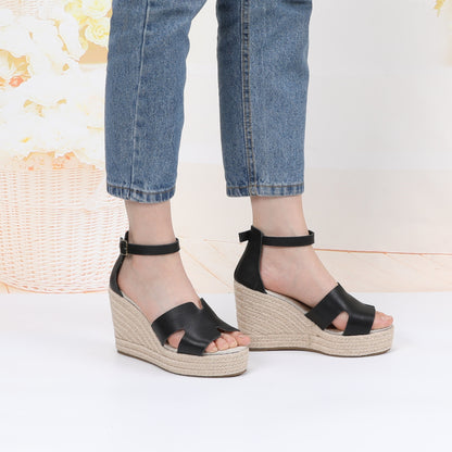 TONIVIS black leather platform wedge sandals on model